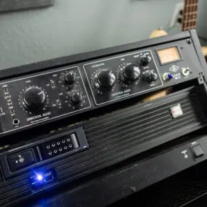 A black and silver stereo system with blue light.