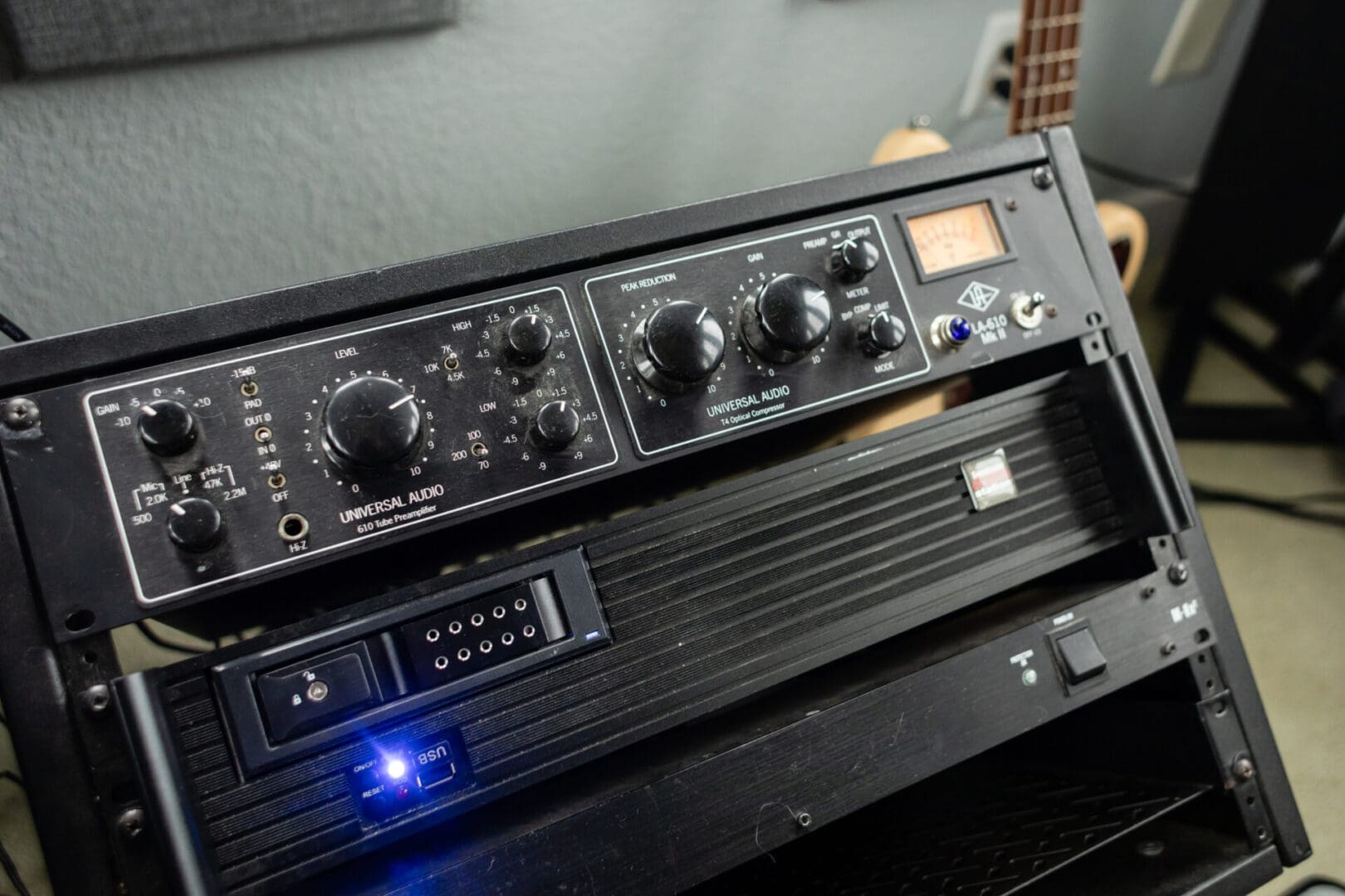 A black and silver stereo system with blue light.