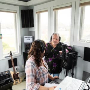 A woman and man in a recording studio.