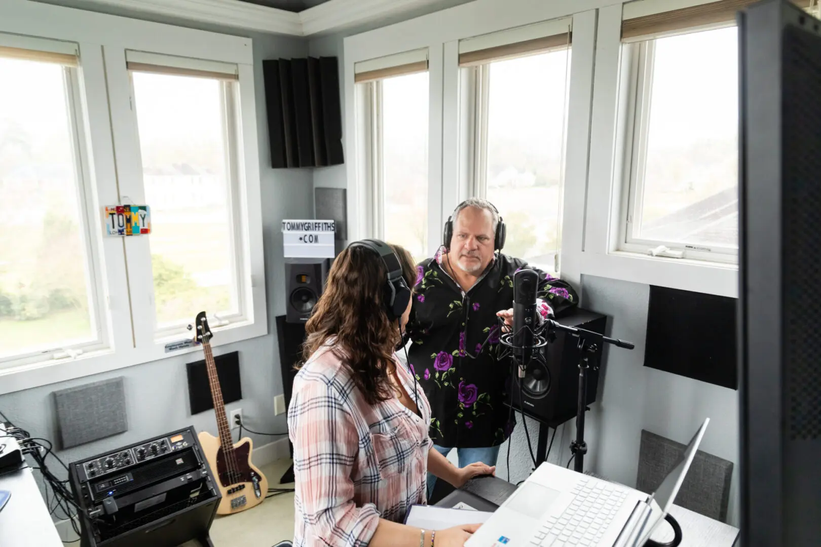 A woman and man in a recording studio.